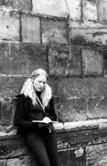 Woman Writing Against a Wall in Prague